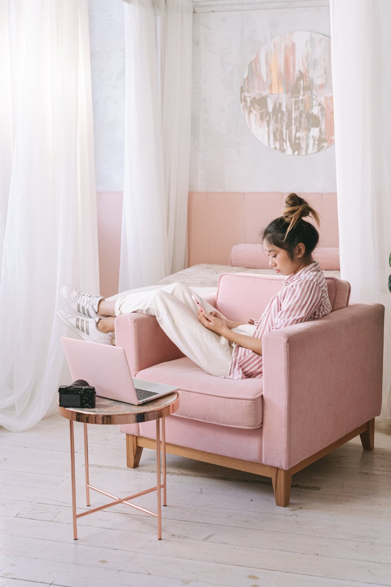 Woman Sitting on Sofa Chair Using Cellphone